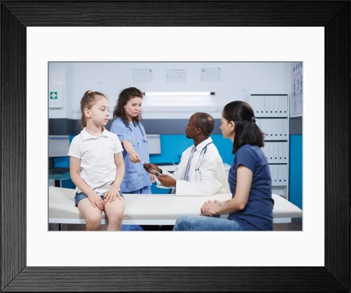 Framed Print : Medical staff advising female patients
