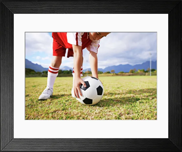 Framed Print : Child, hands and soccer ball for sports on green grass in training or practice with clouds and blue sky Framed Print : Child, hands and soccer ball for sports on green grass in training or practice with clouds and blue sky