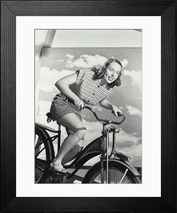 Framed Print : Woman in stripped blouse smiling on bicycle Framed Print : Woman in stripped blouse smiling on bicycle