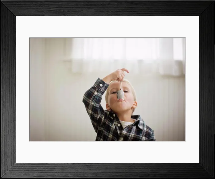 Framed Print : Portrait of a young boy with a spoon in his mouth Framed Print : Portrait of a young boy with a spoon in his mouth