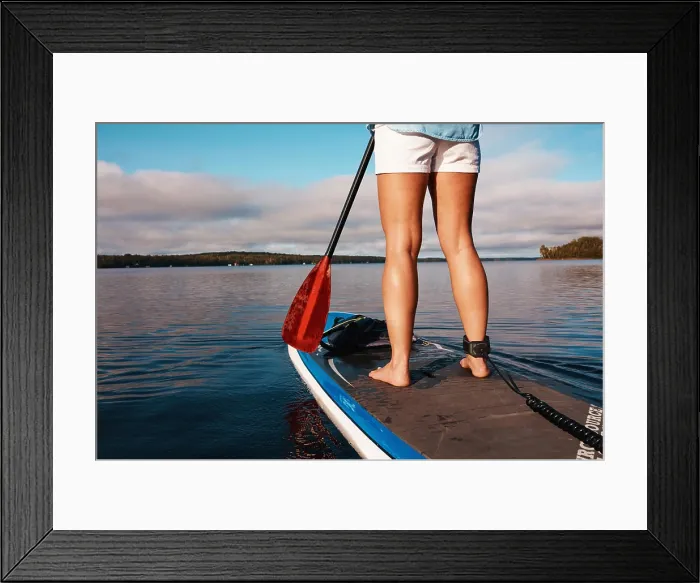 Framed Print : Woman, legs and paddle board in lake water for calm exercise with vacation Framed Print : Woman, legs and paddle board in lake water for calm exercise with vacation