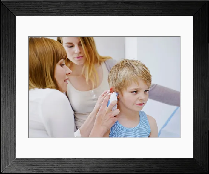 Framed Print : Doctor measuring a child's temperature Framed Print : Doctor measuring a child's temperature