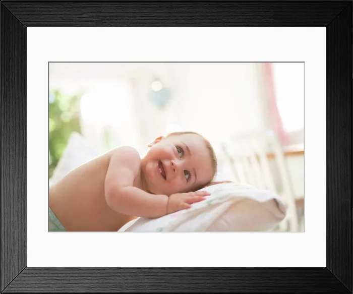 Framed Print : Baby boy leaning on pillow, London, UK Framed Print : Baby boy leaning on pillow, London, UK