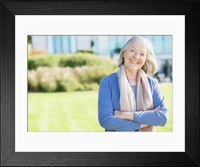 Framed Print : Smiling older woman standing outdoors, East Grinstead, UK