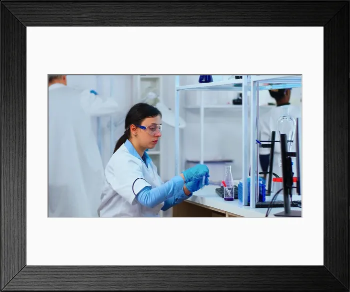 Framed Print : Woman scientist filling liquid test tube with pipette Framed Print : Woman scientist filling liquid test tube with pipette