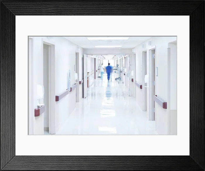 Framed Print : Doctor walking down hospital corridor Framed Print : Doctor walking down hospital corridor