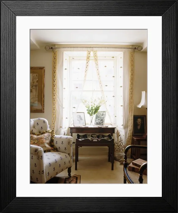 Framed Print : Small cream patterned armchair beside window with patterned cream voile curtains Framed Print : Small cream patterned armchair beside window with patterned cream voile curtains