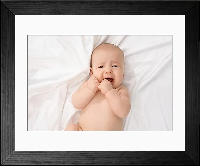 Framed Print : Top view of child crying while looking at camera