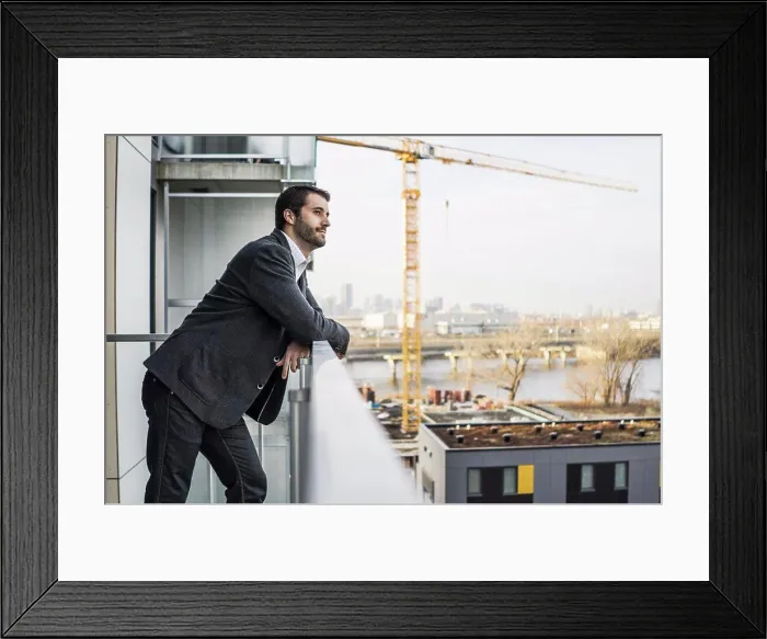 Framed Print : Young contractor standing with confidence on condo balcony Framed Print : Young contractor standing with confidence on condo balcony