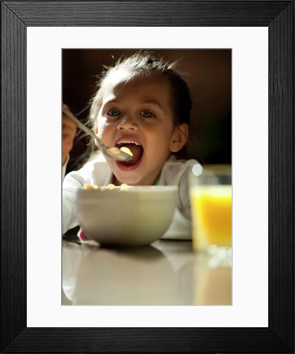 Framed Print : USA, Utah, Orem, portrait of girl (8-9) eating Framed Print : USA, Utah, Orem, portrait of girl (8-9) eating