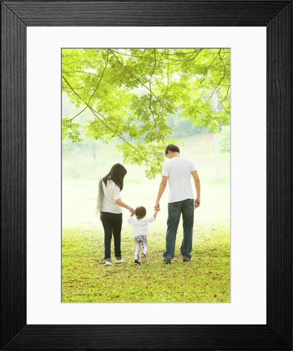 Framed Print : Parents and daughter having fun and walking on green lawn Framed Print : Parents and daughter having fun and walking on green lawn