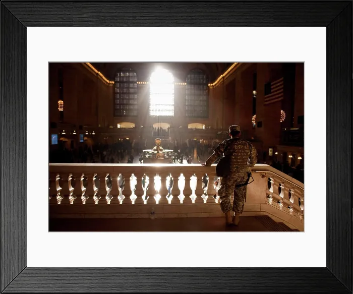 Framed Print : A man wearing a camouflage military uniform looks out over the concourse in Grand Central station Framed Print : A man wearing a camouflage military uniform looks out over the concourse in Grand Central station
