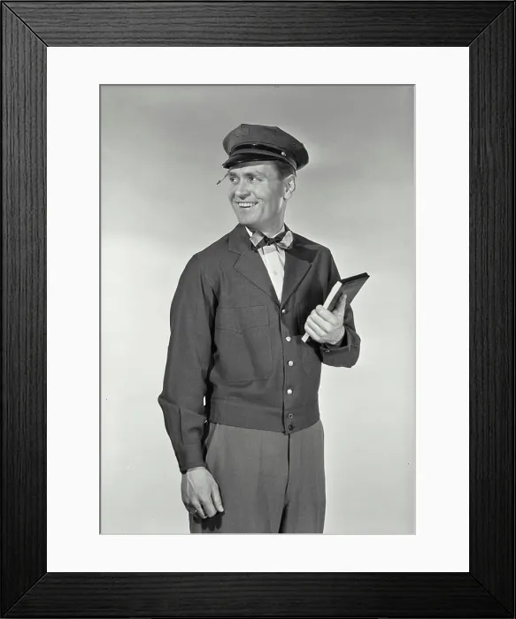 Framed Print : Vintage Photograph. Mailman in uniform with pencil stuck in hat brim holding up notepad smiling Framed Print : Vintage Photograph. Mailman in uniform with pencil stuck in hat brim holding up notepad smiling