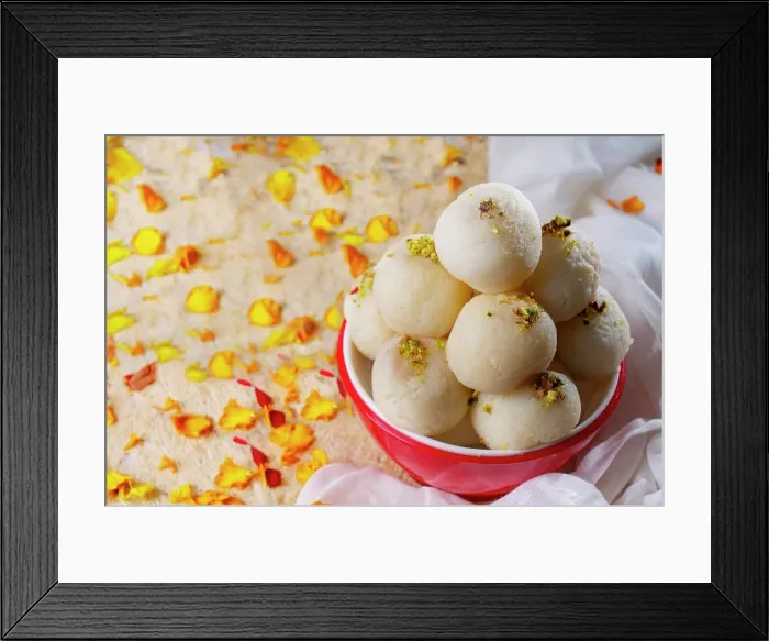 Framed Print : Mouth watering white rasgullas kept in a bowl with sprinkled pistachios