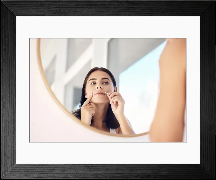 Framed Print : Beauty, mirror and tweezers with a woman in the bathroom of her home for hair removal or skincare