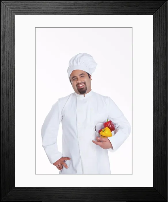 Framed Print : Portrait of chef with bowl of capsicum Framed Print : Portrait of chef with bowl of capsicum
