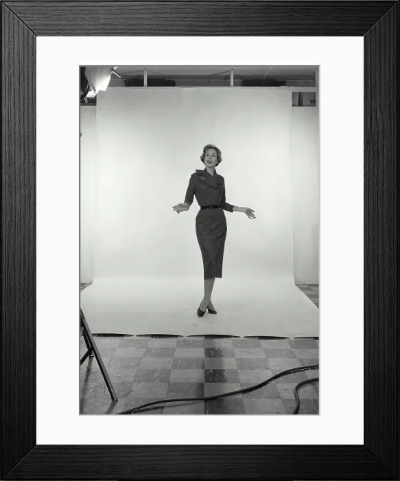 Framed Print : Vintage Photograph. Full length view of Businesswoman on white studio background, holding hands out to side, Frame 1