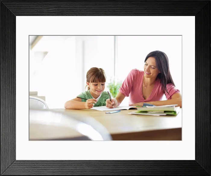 Framed Print : Mother helping daughter with homework Framed Print : Mother helping daughter with homework