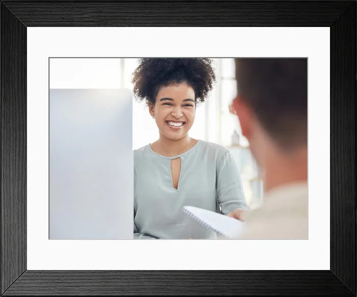 Framed Print : Report, smile and business woman giving a document to a manager while working on a computer Framed Print : Report, smile and business woman giving a document to a manager while working on a computer