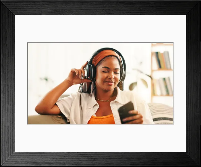 Framed Print : Headphones, happy woman and relax with mobile on sofa with podcast Framed Print : Headphones, happy woman and relax with mobile on sofa with podcast