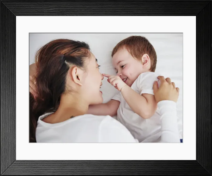 Framed Print : Love, mother and baby in bed from above