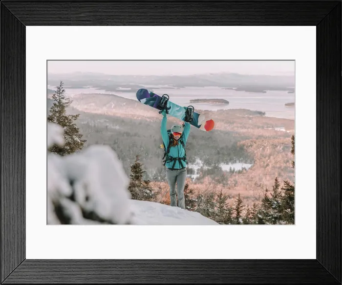 Framed Print : Woman with ski goggles and snowboard on mountain overlooking lake