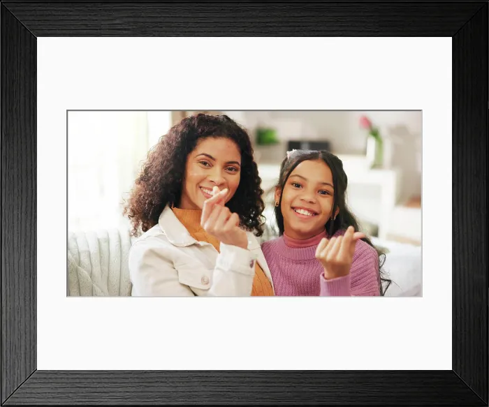 Framed Print : Finger heart, portrait and woman with daughter on sofa in living room of home for gratitude or love