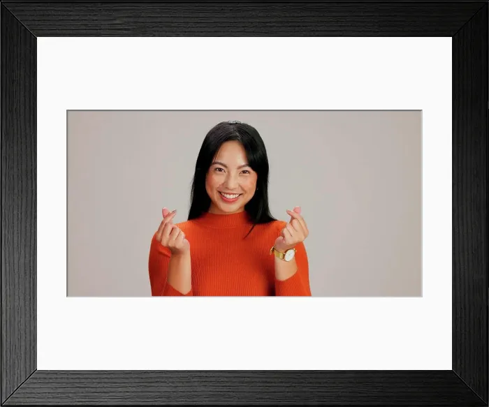 Framed Print : Asian girl, finger heart and happy in studio portrait