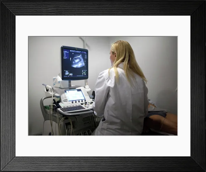 Framed Print : Reportage in a radiology centre in Haute-Savoie, France. A technician carries out a scan of the kidneys and prostate Framed Print : Reportage in a radiology centre in Haute-Savoie, France. A technician carries out a scan of the kidneys and prostate