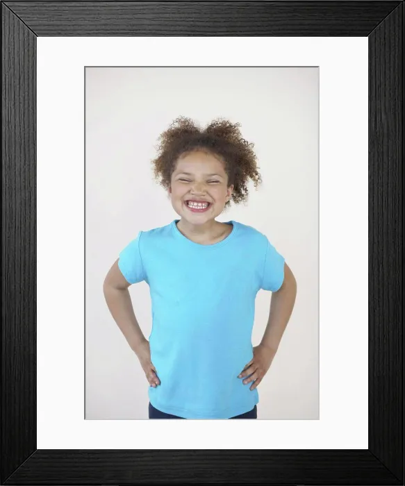 Framed Print : Close-up of a girl standing with her arms akimbo Framed Print : Close-up of a girl standing with her arms akimbo