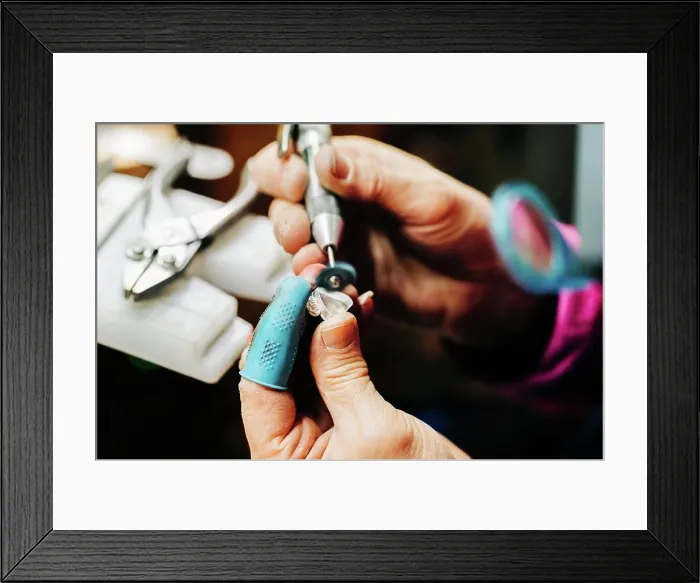 Framed Print : Close up of jewelers hands sanding with handheld bench grinder Framed Print : Close up of jewelers hands sanding with handheld bench grinder