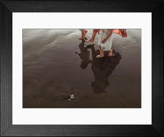 Framed Print : Reflection in ocean water of mother walking two daughters at beach