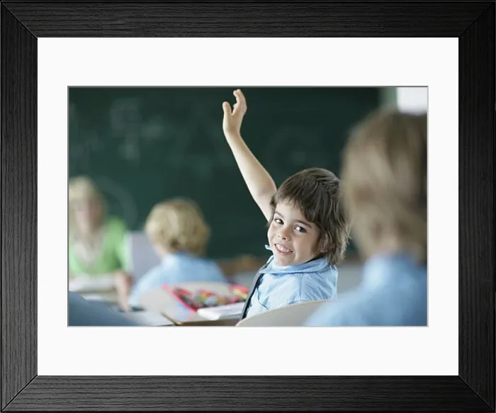 Framed Print : School boy raising hand in class Framed Print : School boy raising hand in class