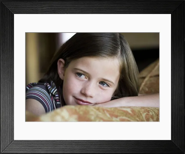 Framed Print : Close-up of young girl's smiling face Framed Print : Close-up of young girl's smiling face