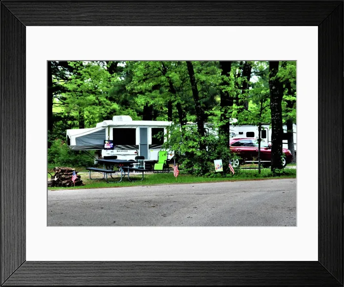 Framed Print : A camper is set up at a campsite May 26