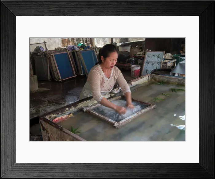 Framed Print : The jute paper production (fibers are being spread in water in a sift) in Ban Xang Khong Framed Print : The jute paper production (fibers are being spread in water in a sift) in Ban Xang Khong