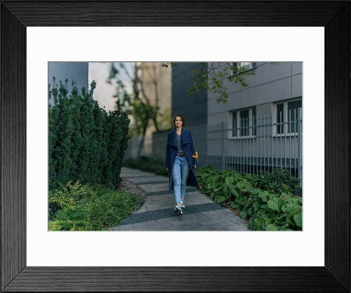 Framed Print : Confident young woman enjoying a walk in an urban neighborhood Framed Print : Confident young woman enjoying a walk in an urban neighborhood