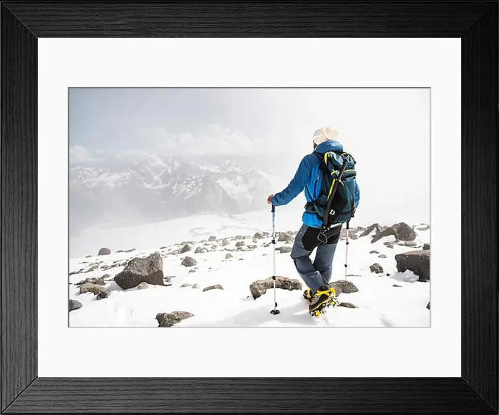 Framed Print : Portrait of a bearded guide with a backpack and an ice ax and sticks for Nordic walking in a hat Framed Print : Portrait of a bearded guide with a backpack and an ice ax and sticks for Nordic walking in a hat
