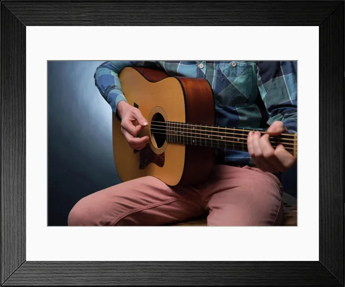 Framed Print : Young man playing on acoustic guitar close up Young man playing on acoustic guitar close up on dark blue background Framed Print : Young man playing on acoustic guitar close up Young man playing on acoustic guitar close up on dark blue background