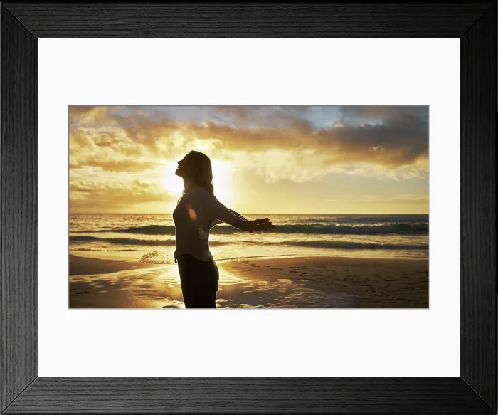 Framed Print : Silhouette of a woman on the beach at sunset outside Framed Print : Silhouette of a woman on the beach at sunset outside