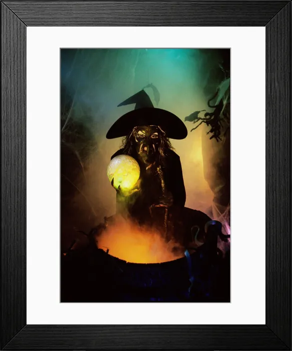 Framed Print : Witch holding a crystal ball standing in front of a cauldron Framed Print : Witch holding a crystal ball standing in front of a cauldron