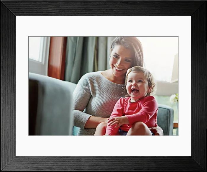 Framed Print : Mom, toddler and happy with laughing on sofa in home living room with care Framed Print : Mom, toddler and happy with laughing on sofa in home living room with care