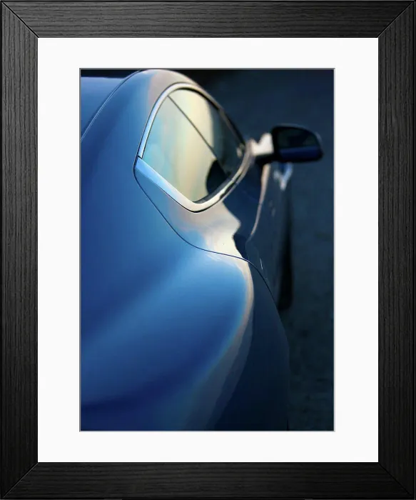 Framed Print : Exterior detail view of a blue 2012 Aston Martin Rapide showing the right doors and rear view mirror Framed Print : Exterior detail view of a blue 2012 Aston Martin Rapide showing the right doors and rear view mirror