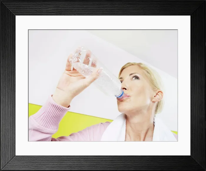 Framed Print : Woman drinking water in health club Framed Print : Woman drinking water in health club