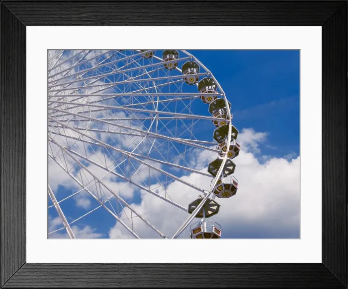 Framed Print : Ferris wheel in the park, a close-up view from the bottom against the blue sky Framed Print : Ferris wheel in the park, a close-up view from the bottom against the blue sky