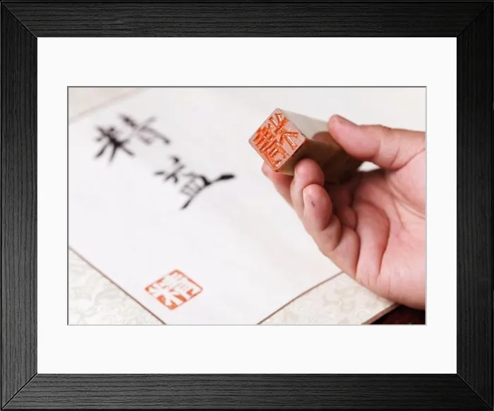 Framed Print : Calligrapher holding a stamp