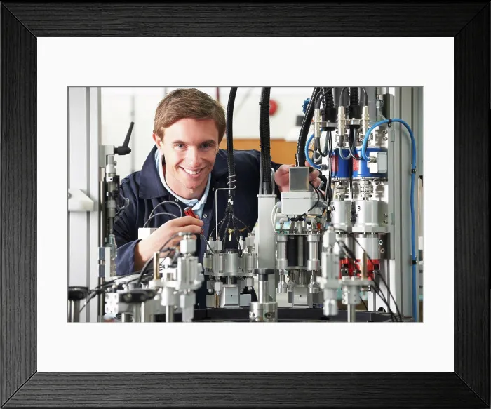 Framed Print : Engineer Working On Complex Equipment In Factory Framed Print : Engineer Working On Complex Equipment In Factory