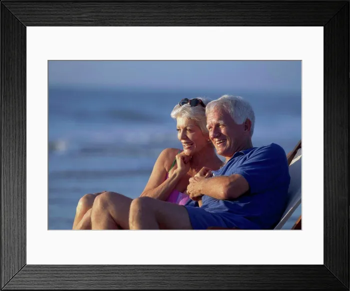 Framed Print : Senior couple sitting together in a chair and smiling Framed Print : Senior couple sitting together in a chair and smiling