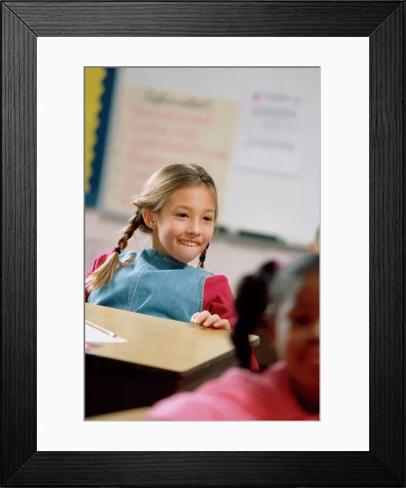 Framed Print : Girl smiling in a classroom Framed Print : Girl smiling in a classroom