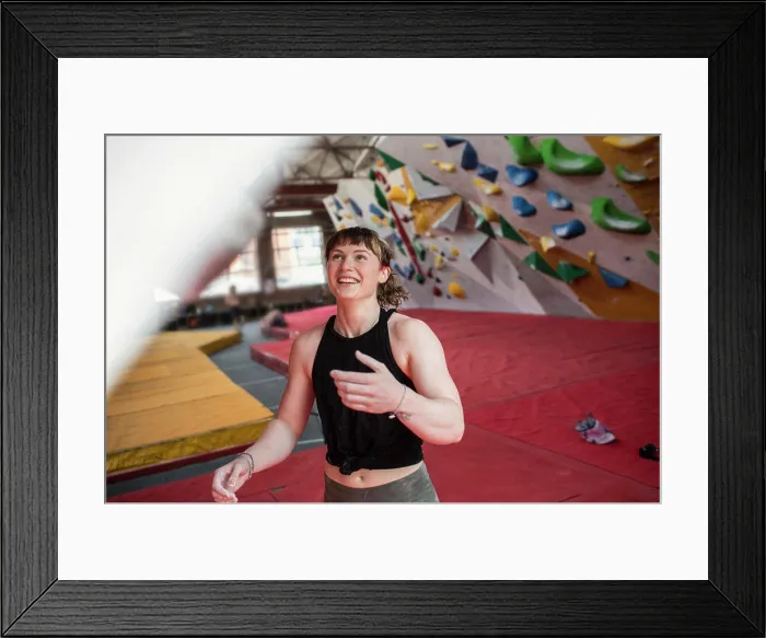Framed Print : Happy young female rock climber in climbing gym Framed Print : Happy young female rock climber in climbing gym